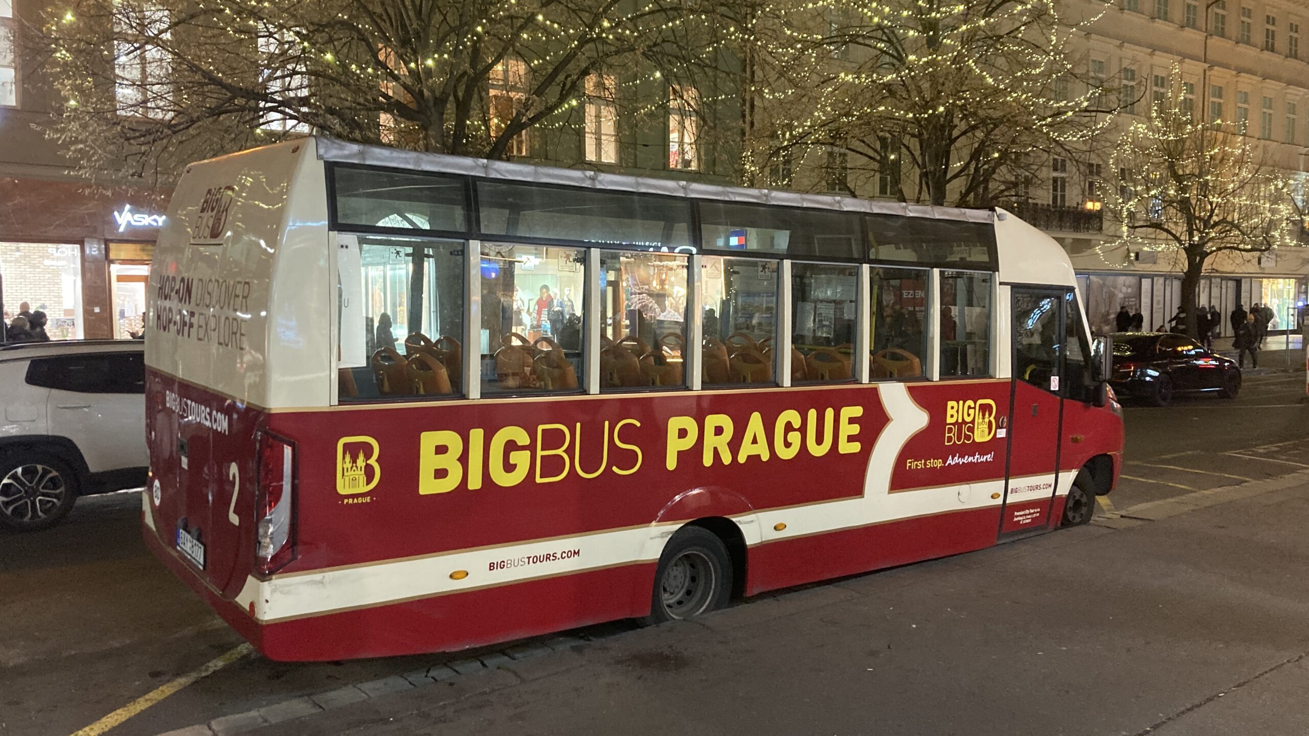 a red and white bus parked on a street
