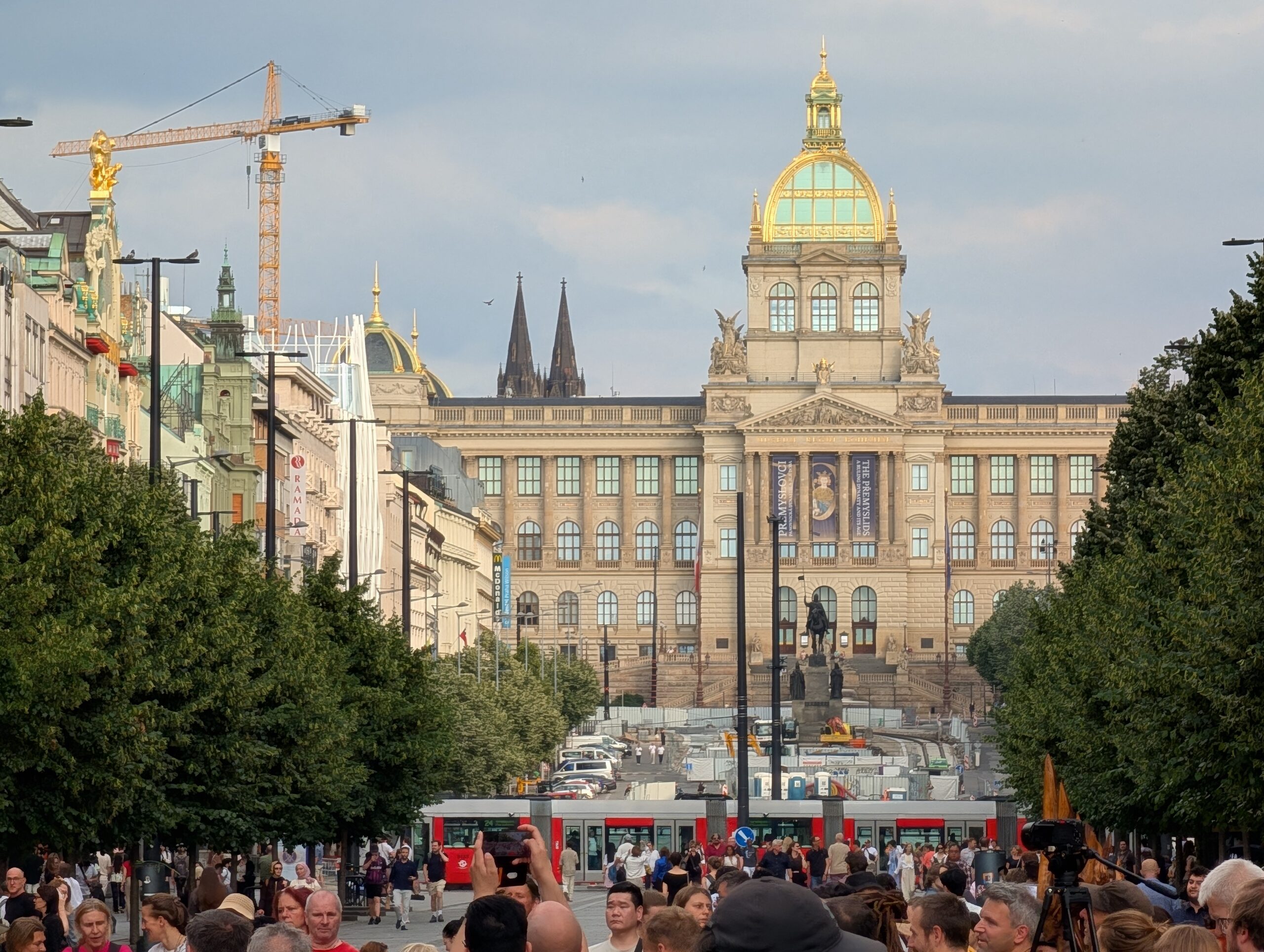Wenzelsplatz in Prag mit zahlreichen Besuchern, Straßenbahnen und Nationalmuseum im Hintergrund